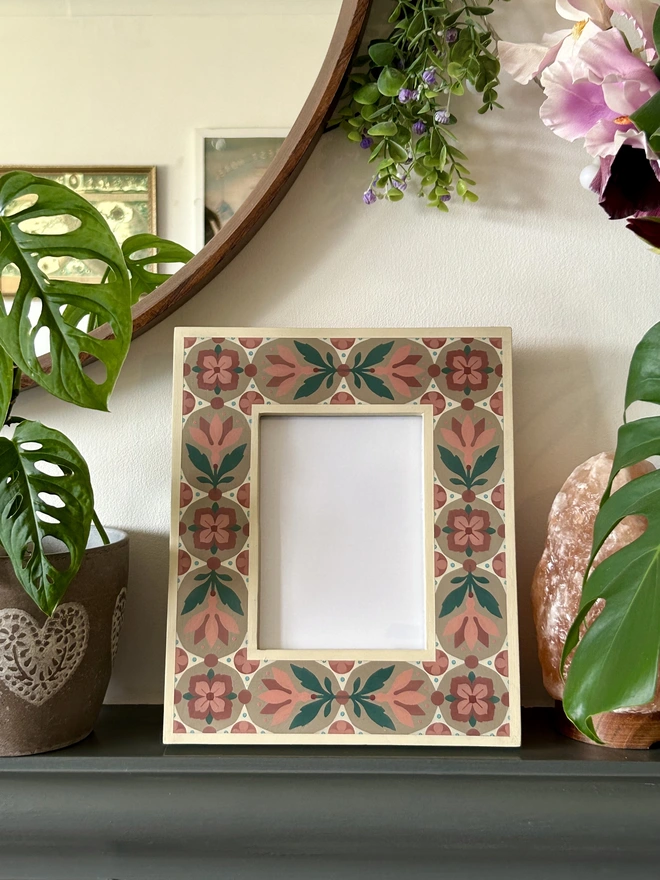 Folk art inspired hand painted decorated flower patterned photo frame painted in pinks, green, cream and light brown