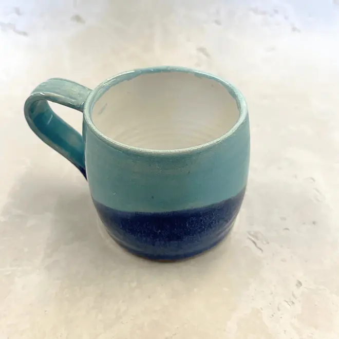 Landscape Large Round Mug, a colourful coffee mug on a stone surface. 