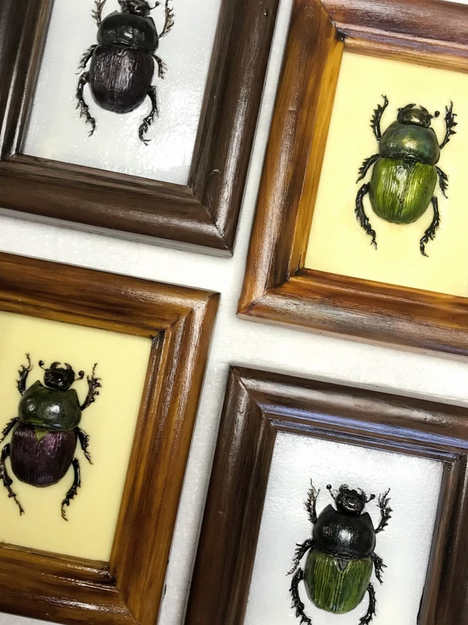 Multicoloured realistic edible chocolate dung beetles in chocolate frames