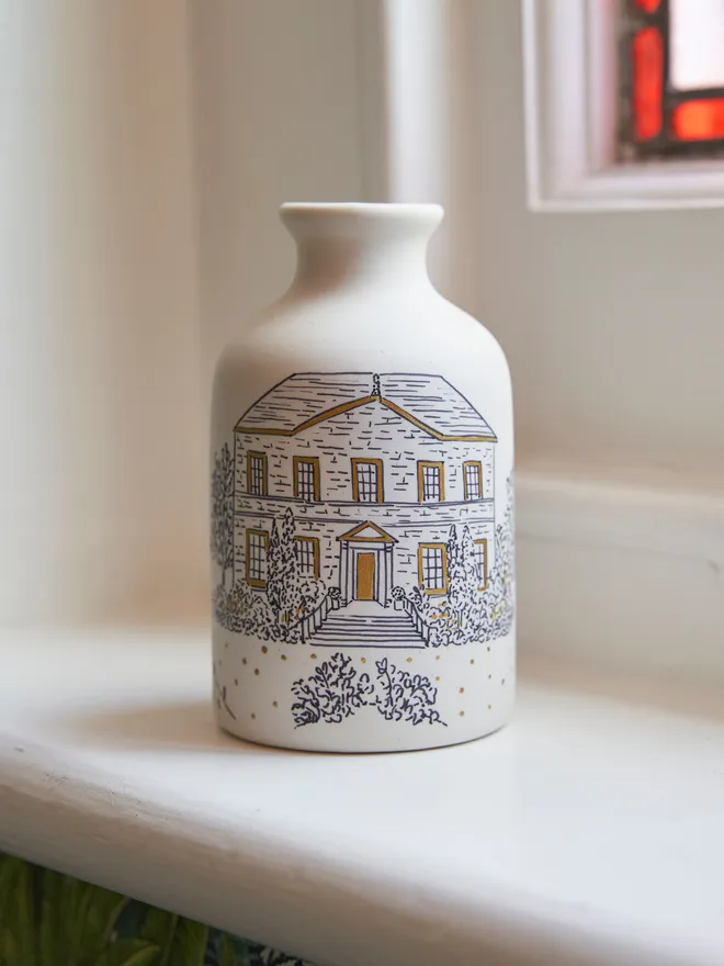 The back of a ceramic vase with black hand written personalisation  