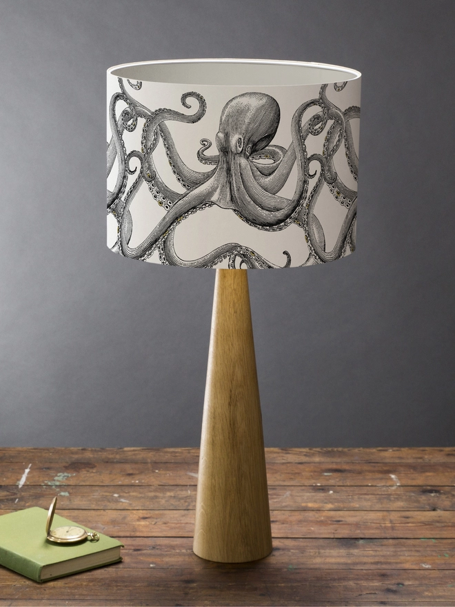 Drum Lampshade featuring Octopus on a wooden base on a shelf with books and ornaments