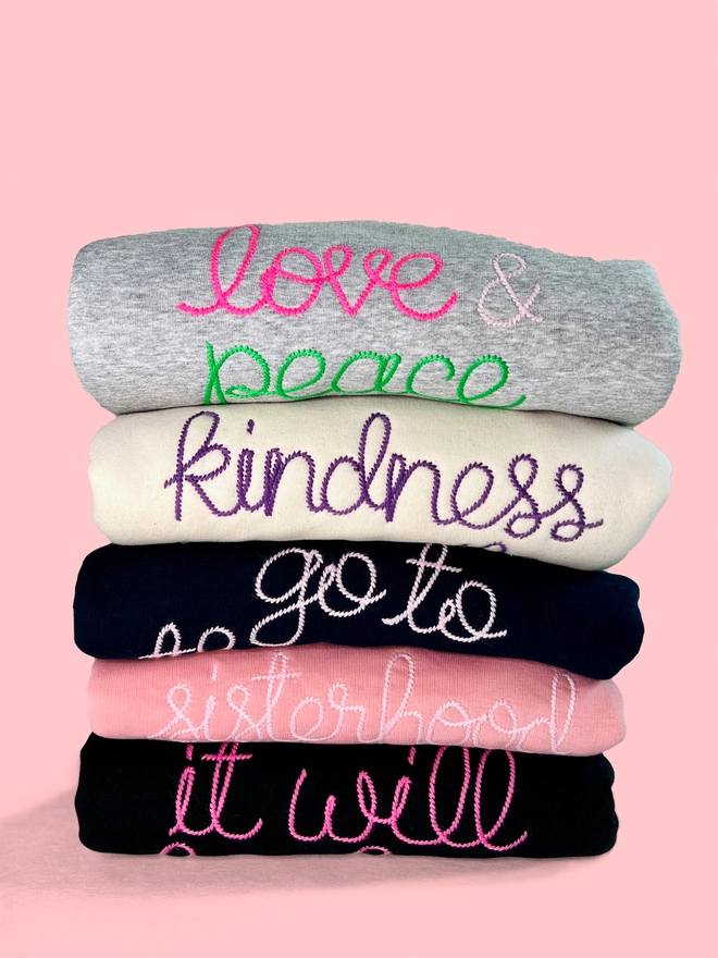 A bundle of colourful embroidered sweatshirts 