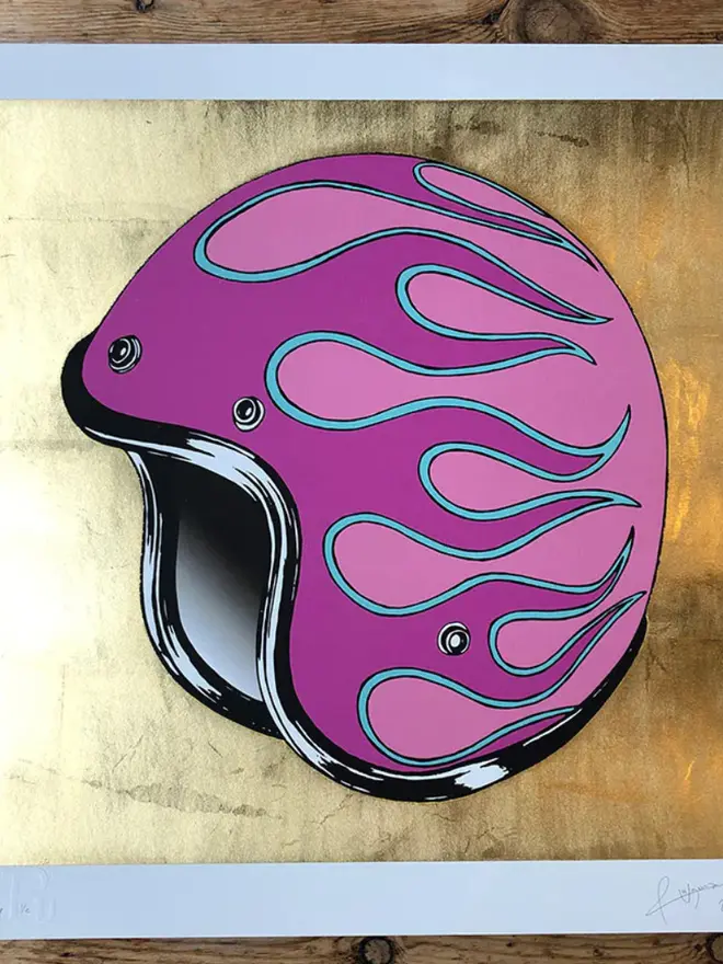 Motor cycle helmet with  a flame design on a gold  background. 
