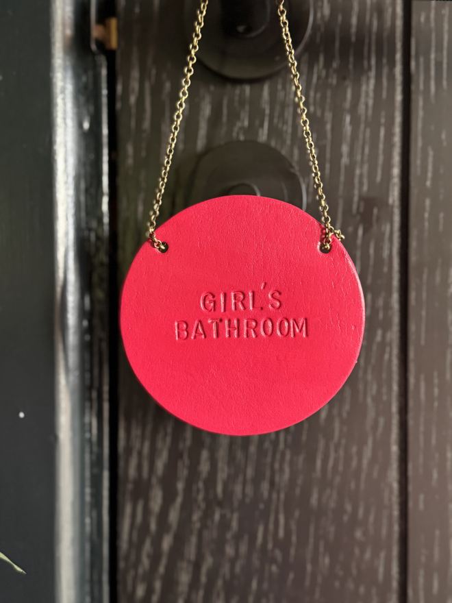 magenta leather bathroom sign