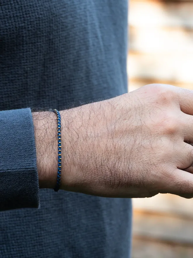 men blue bracelet with bronze