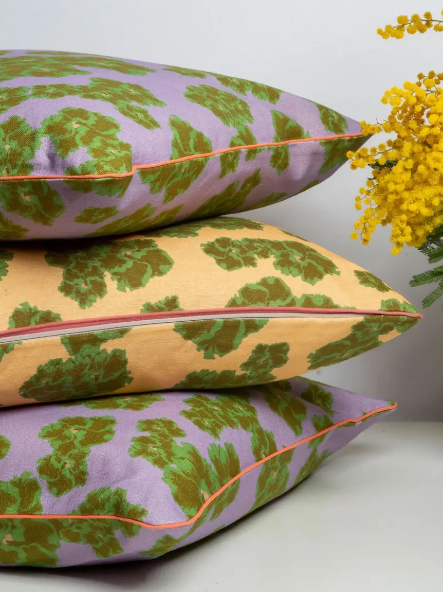 stack of lilac and yellow floral cushions