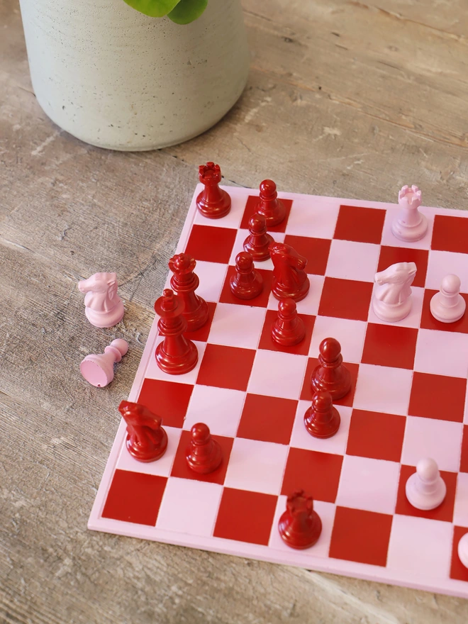 Handmade Jesmonite Chess Board, a handmade colourful chess board sitting on a wooden surface. 