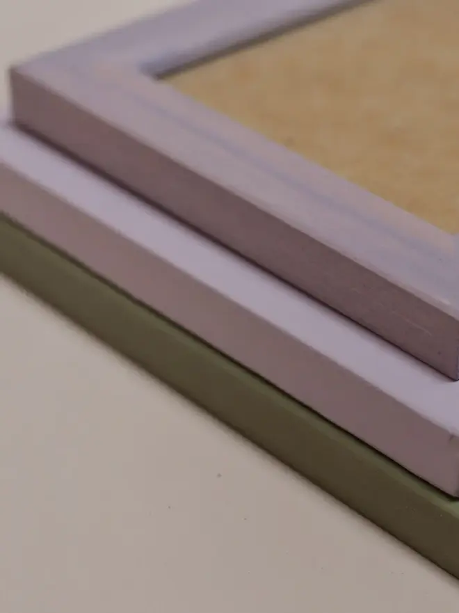 green and purple empty flat wood picture frames