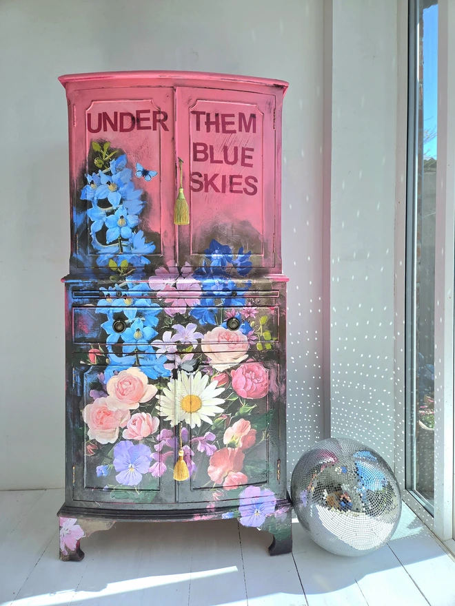 Painted vintage wooden cabinet with pink, blue and floral decoration