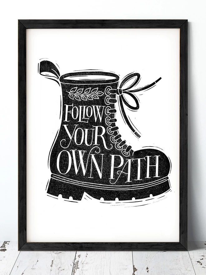 follow your own path lettering in black boot print in black frame