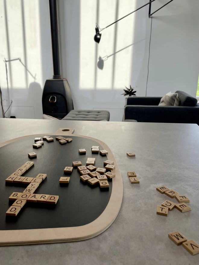 board with scrabble tiles forming words
