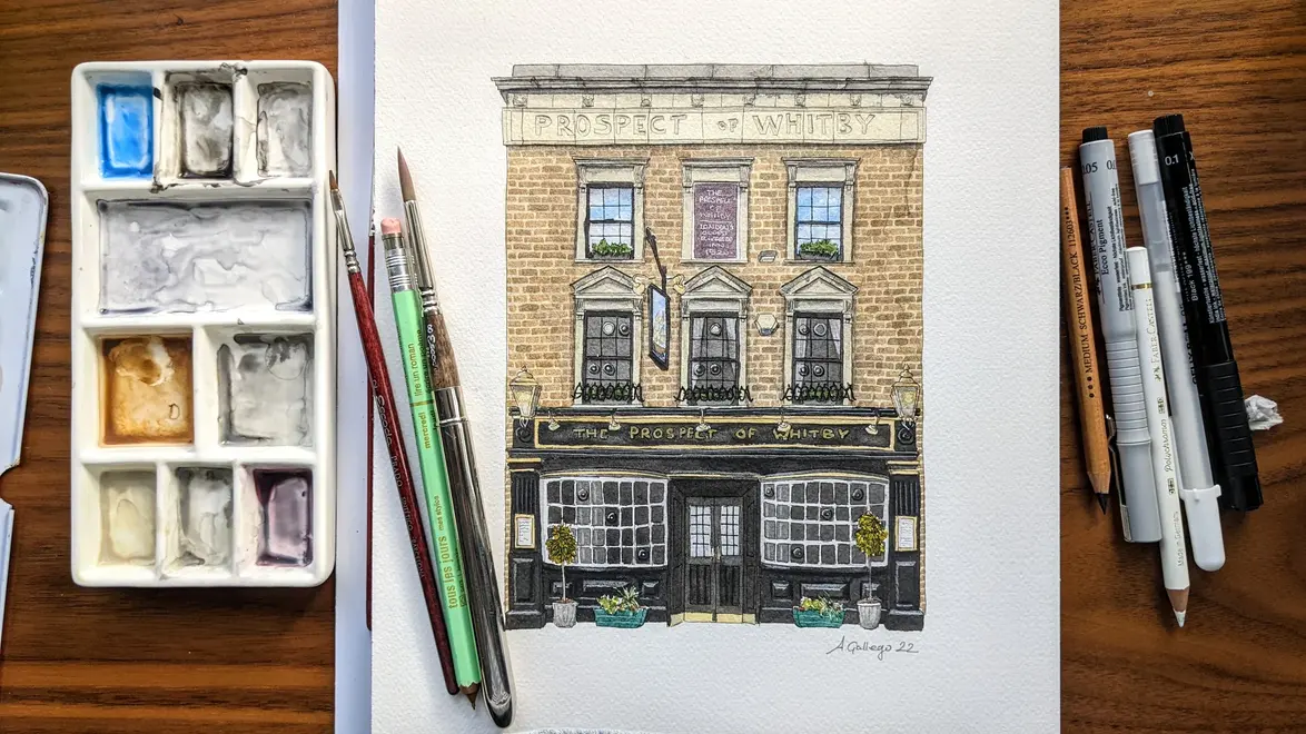 Wapping Prospect of Whitby Giclée Print (Unframed), a print of a pub sitting on a studio table accompanied by other drawing utensils. 