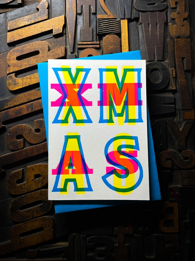 Festive Christmas typographic letterpress card with deep impression print. Very colourful and vibrant. With Tabriz Blue envelope.