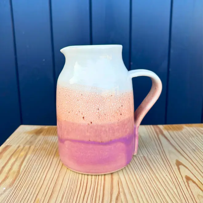 Ice Cream Sundae Jug, a colourful jug sitting on a wooden surface against a navy blue backdrop. 