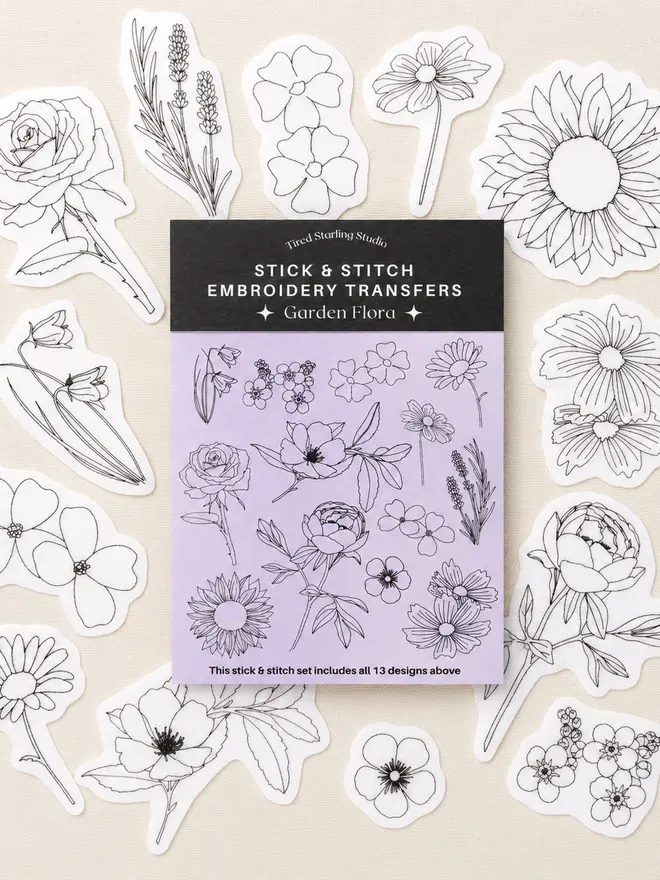 Garden Flora stick and stitch embroidery transfer set featuring 13 floral embroidery designs including roses, peonies, sunflowers, lavender and wildflowers displayed on natural fabric.