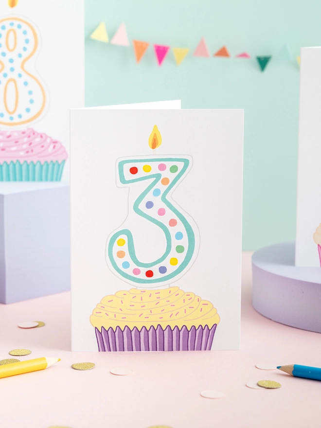 A sweet third birthday card featuring a cupcake and candles