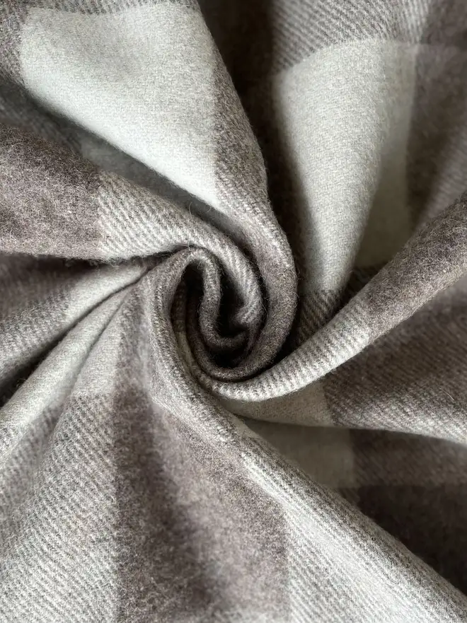 Jacob Blanket, a grey blanket curled up. 