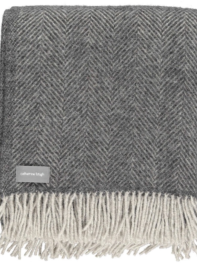 Organic Wool Throw, an organic wool throw folded on a white surface. 