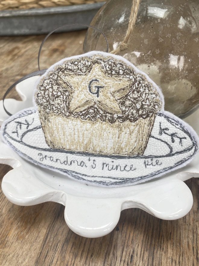 Embroidered Mince Pie Fabric Decoration on a plate with a bauble