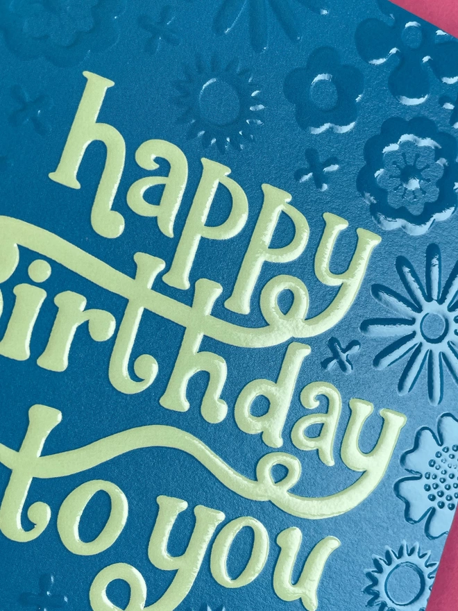 Detailed image of the spot UV and emboss finish that really enhances the Raspberry Blossom greetings card design