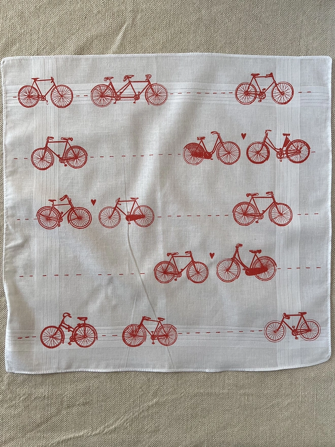 A Mr.PS white cotton handkerchief printed with a pattern of vintage bicycles with little hearts in coral red