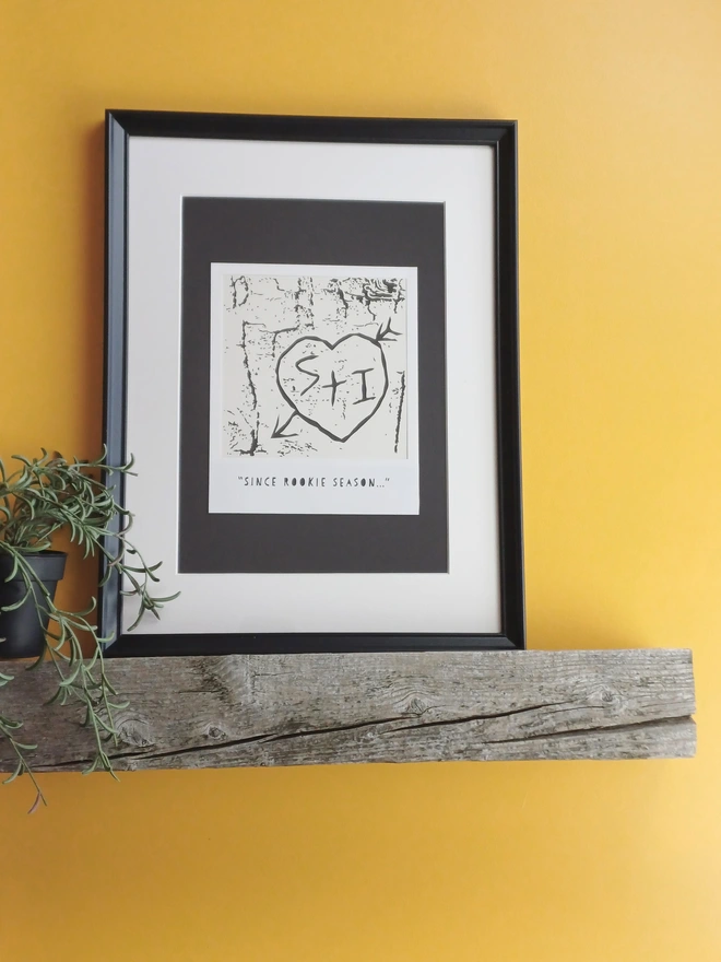 Frame Black and White Papercut showing initials in loveheart carved into tree bark within polaroid style frame. Phrase reads "Since Rookie Season"