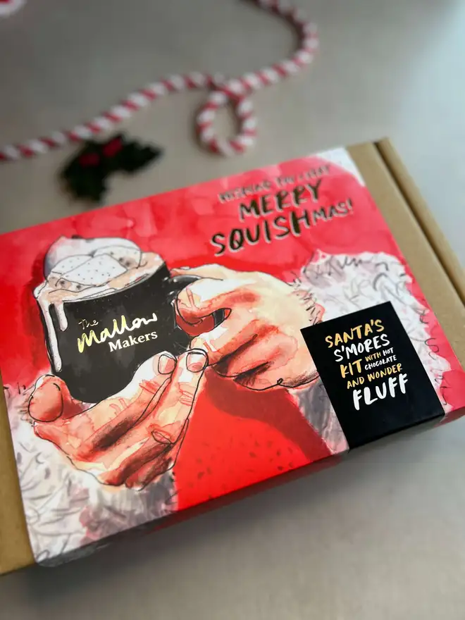 The-Mallow-Makers-Looking-down-at-an-angle-on-santas-smores-kit-christmas-gift-box-with-christmas-ribbon