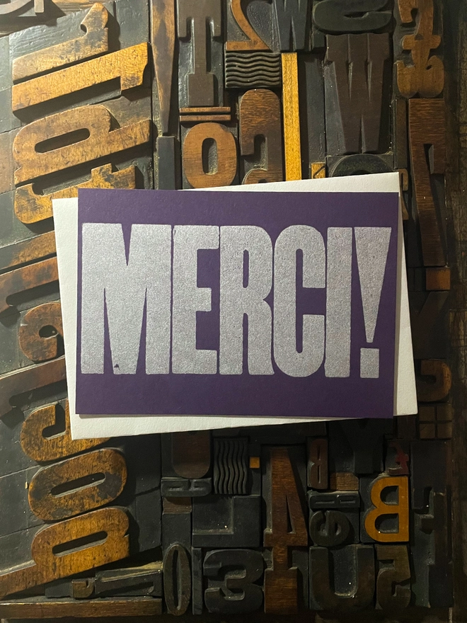 Merci! A beautiful typographic letterpress postcard printed with metallic silver inks printed on rich thick  colourful card with a luxury matching envelope; ideal to send a thank you note to a friend or loved one.