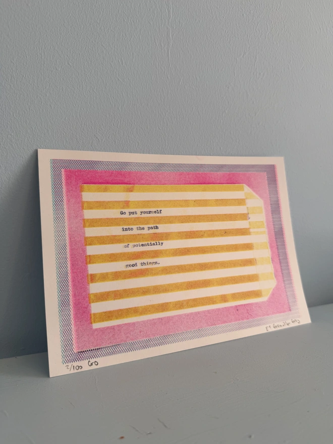 striped art work leaning on a shelf