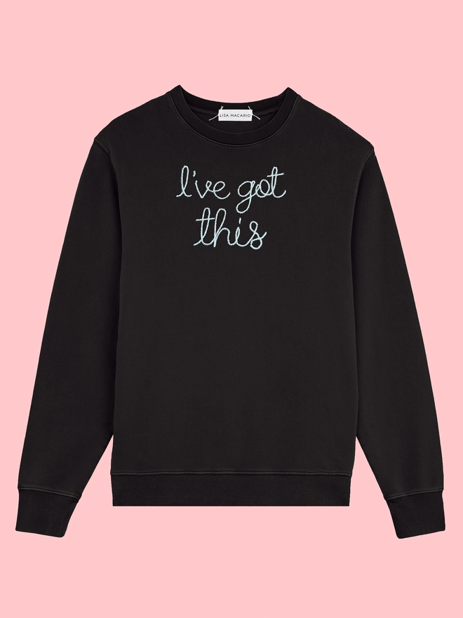 A black sweatshirt embroidered with the phrase I’ve got this on a pink background