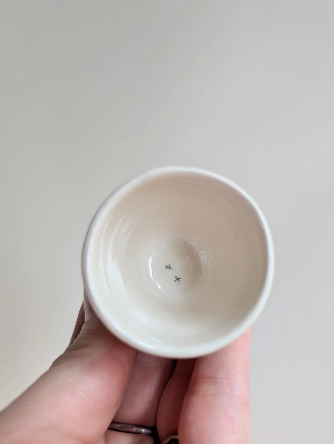 Easter egg cup with bird prints on white pottery