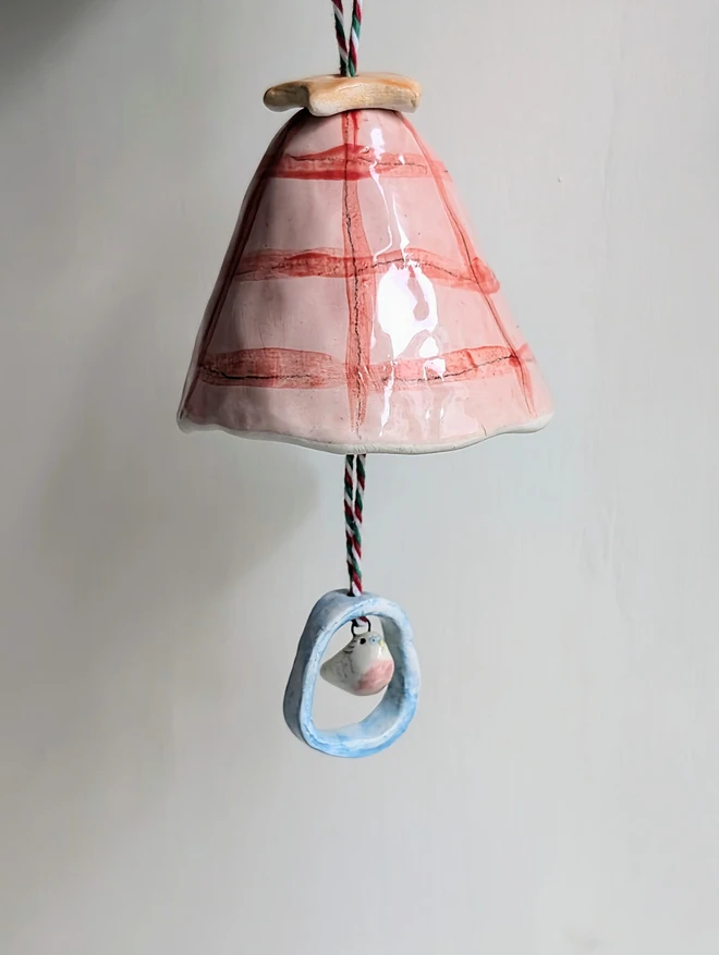 pink and red check budgie bell with a bird hanging in a loop christmas decoration