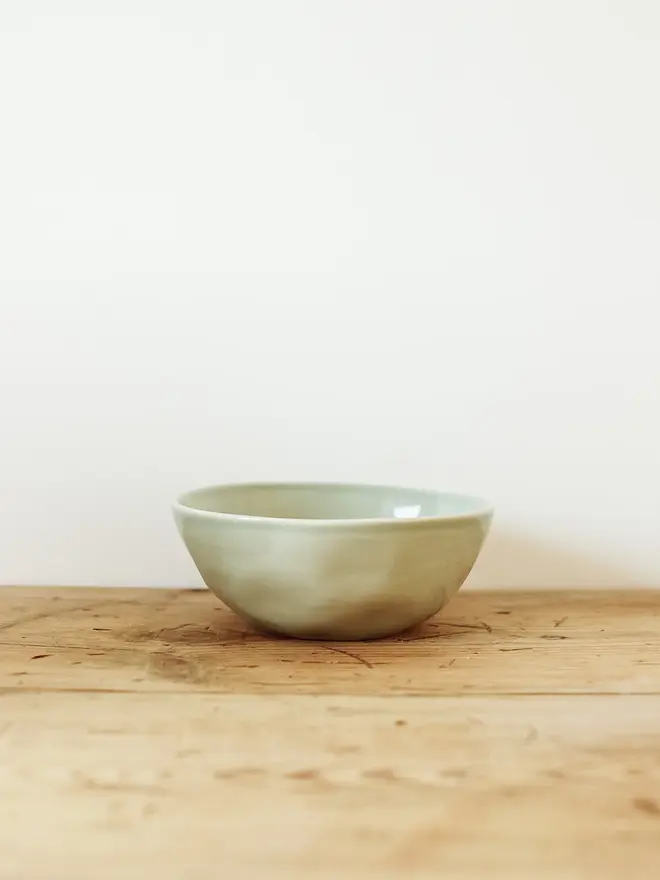 stoneware place setting dining set. a green stoneware bowl.