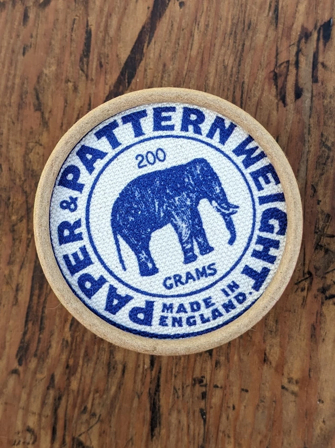 Birds eye view of box containing blue elephant pattern & paper weight