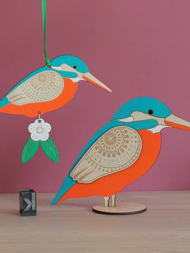 Standing Wooden Kingfisher, orange and blue wooden bird decoration standing on a platform. 