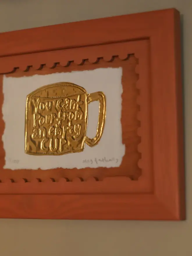 terracotta coloured stamp-shaped mount