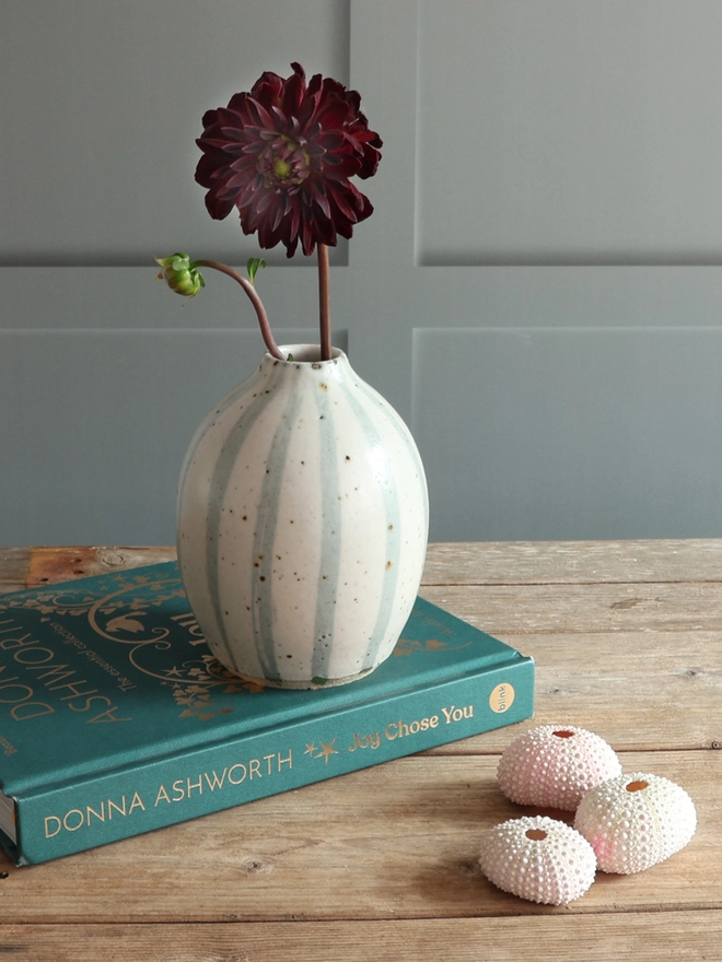  Handmade Ceramic Stoneware Vases in Blue and White Stipe in three different sizes: Small, medium and large. The vases sit on a wooden surface. 