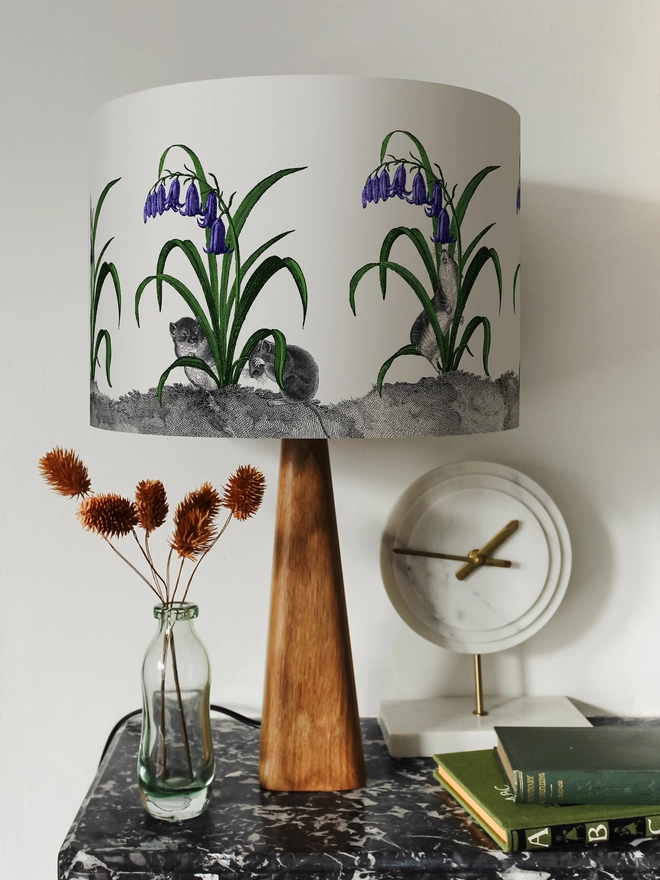 A whimsical lampshade featuring adorable mice hiding among bluebells, creating a charming woodland-inspired design.
