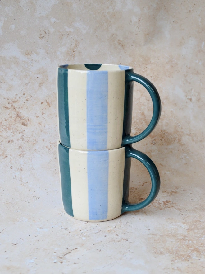 Bonbon Mugs — stacked handmade ceramic striped mugs in blue and cream