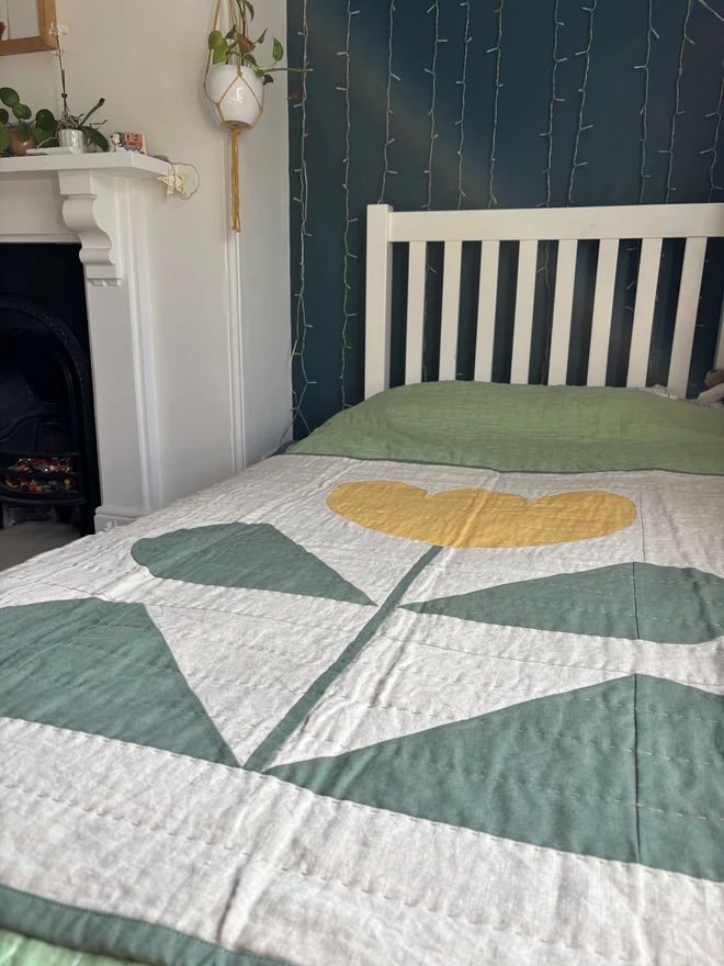 Grow & Bloom Yellow Throw Quilt. A yellow flower quilt throw on single bed,