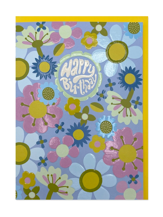  vibrant Birthday card with a ‘Happy Birthday’ message sitting within the centre of a flower, surrounded by a funky 70’s inspired floral pattern design, completed with a spot UV and embossed finish that really makes the birthday card shine