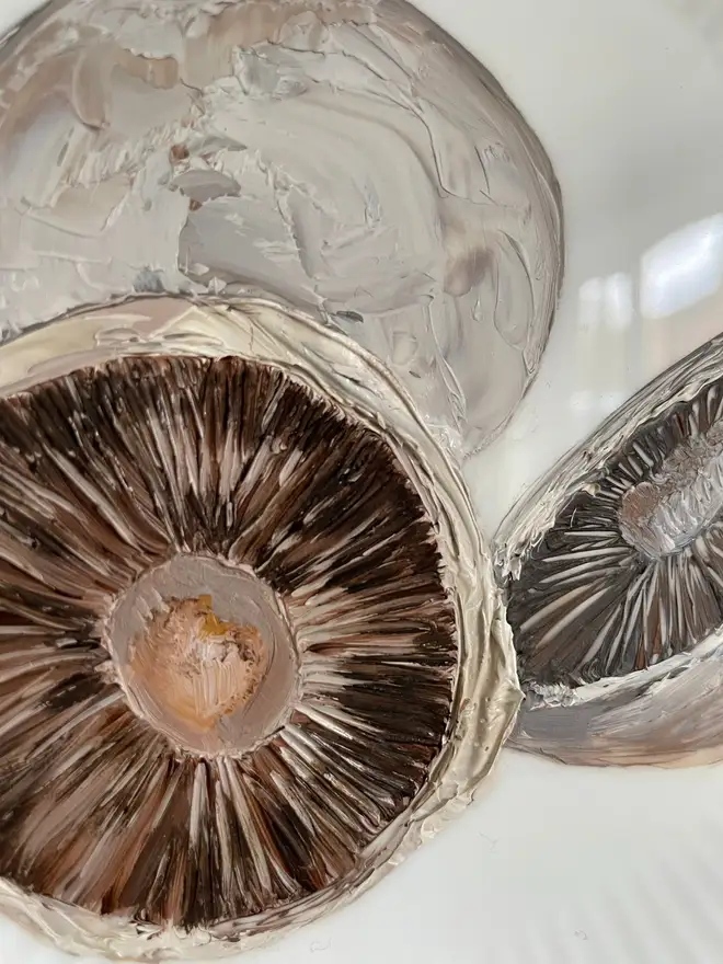 Zoom-in on the Oil Painted Breakfast Mushroom On A vintage plate, hanging in a grey wall. 