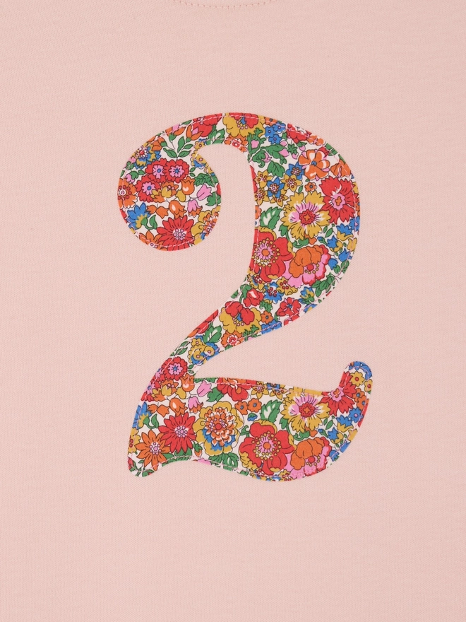 a pink number birthday t-shirt featuring a floral liberty number 2 on the front