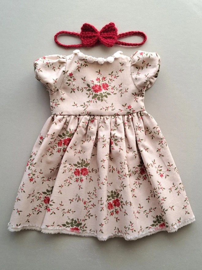 Close-up of a handmade vintage rose floral cotton dress for Veronica Bunny, showing puff sleeves and gathered skirt