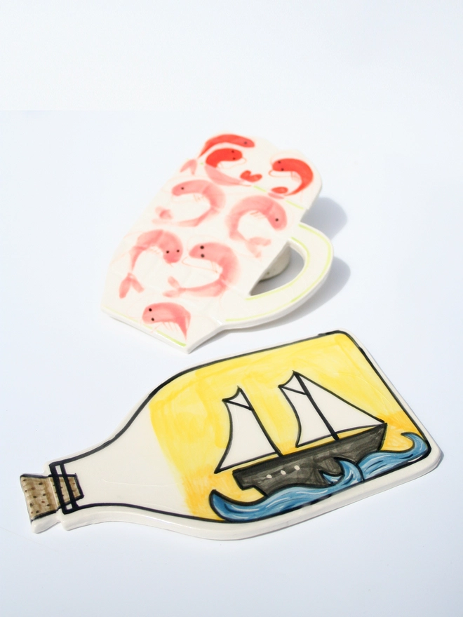 handmade ceramic ship in bottle and pint of prawns wall hanging 