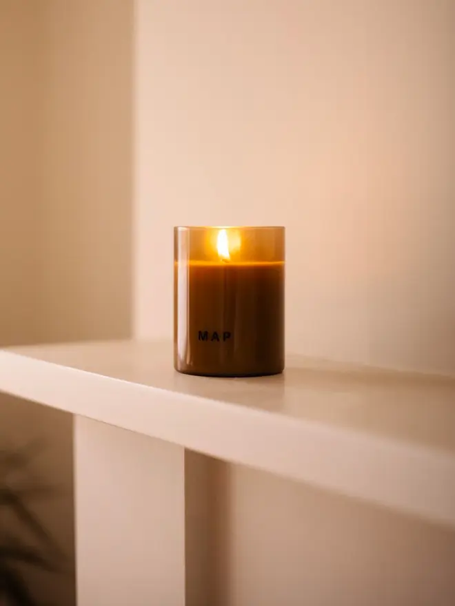 road to marrakesh rose and petitgrain soy candle. candle placed on mantelpiece.