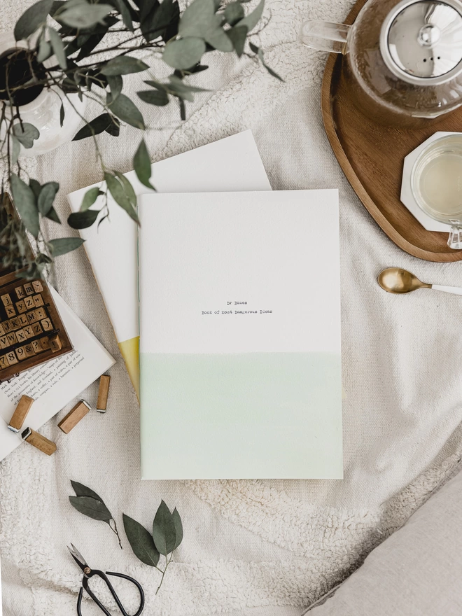 Pale green and white A4 personalised notebook with text typed on a typewriter