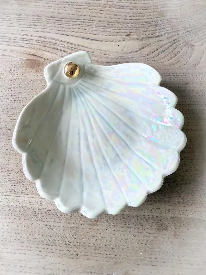 Handmade Porcelain Sea Shell Trinket Dish, positioned on a table. 