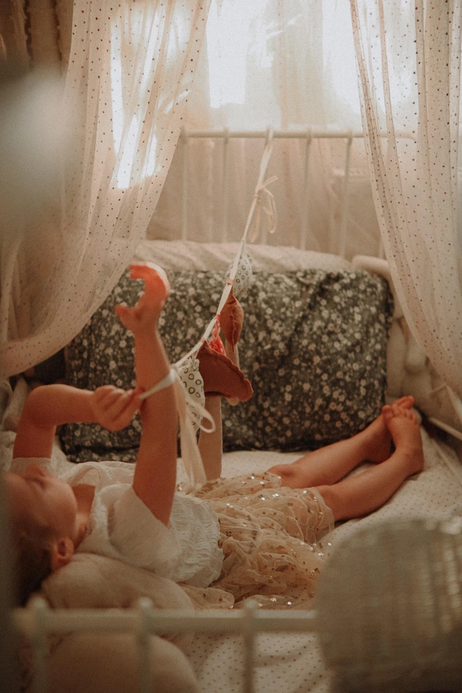Mushroom Garland Decoration, a child playing with their hanging mushroom bunting in their bedroom.  