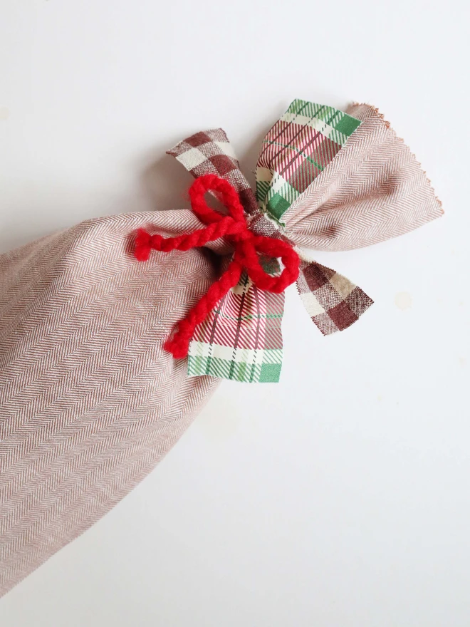 Herringbone fabric gift bag with check cotton bows and red wool bow